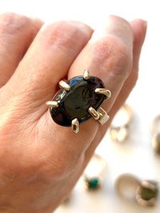 Polished garnet claw set ring